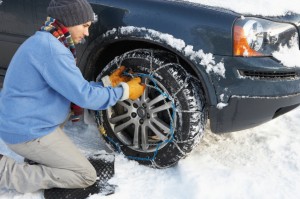 Man Putting Snow Chains on tire