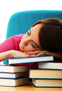 girl sleeping on books